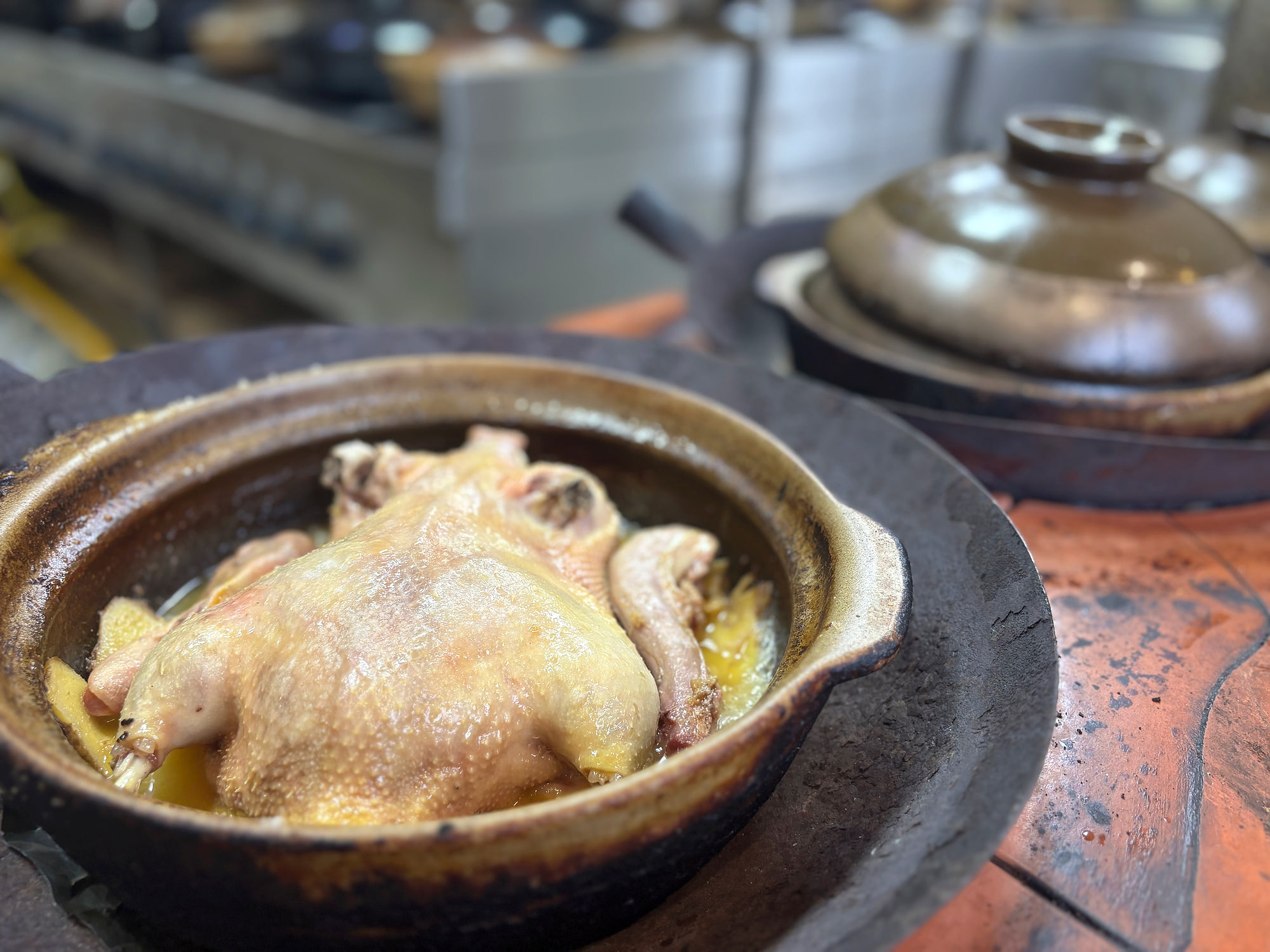 Salt-baked Muscovy duck cooking in a clay pot at Zhong Ji in Quanzhou